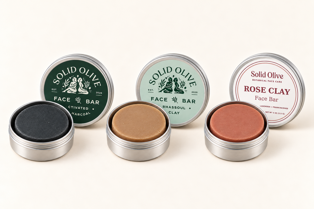 Activated Charcoal, Rhassoul Clay, and Rose Clay face bars in aluminum tins