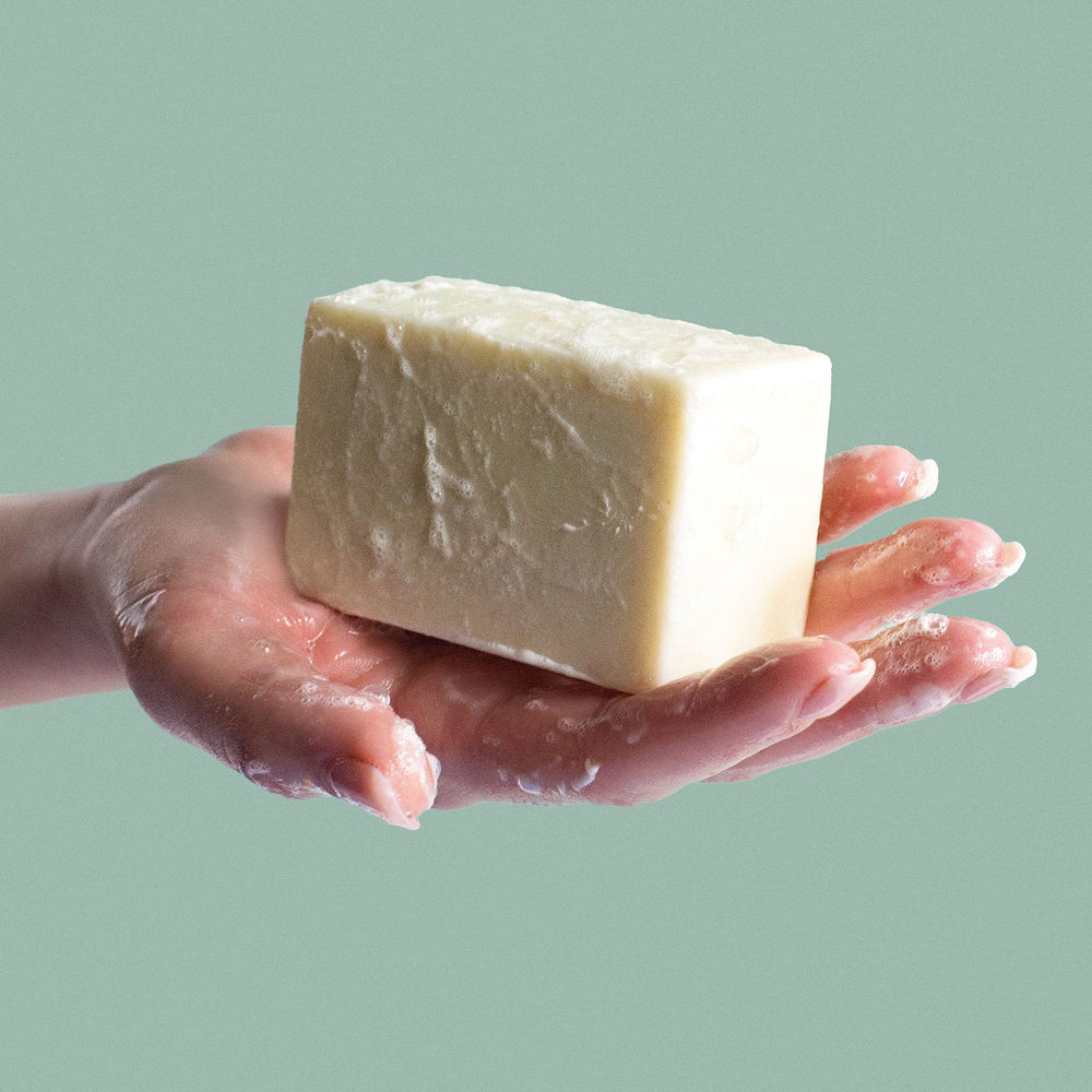 Bar of  sea salt soap on a textured surface with a purple background