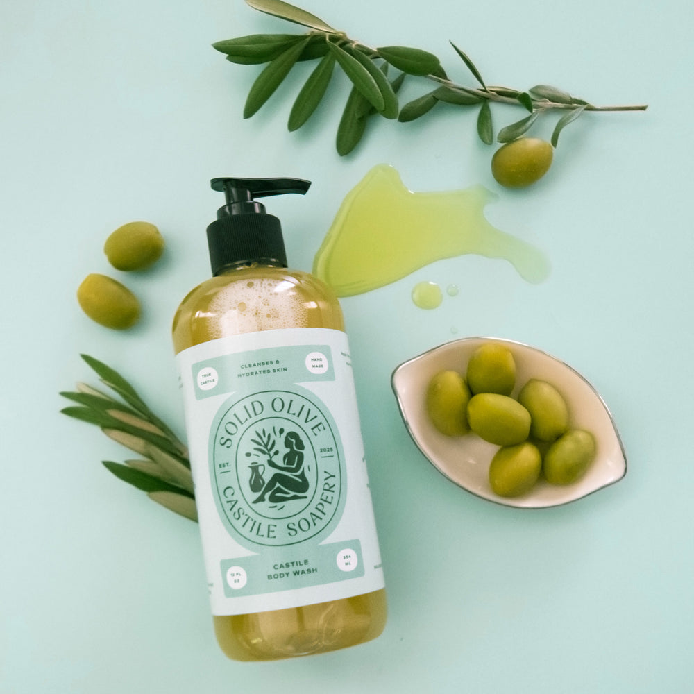 Bottle of Solid Olive & Castile Soapery body wash on a light surface with a purple background