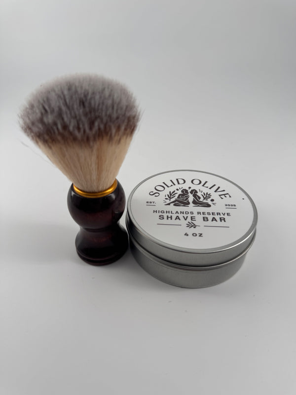 Highlands Reserve shave soap tin beside a shaving brush; brush sold separately