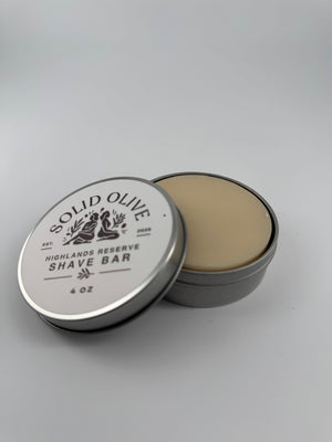 Highlands Reserve 4 oz shave soap in an open silver tin with labeled lid