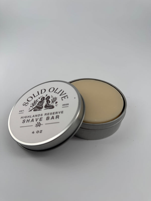 Highlands Reserve 4 oz shave soap in an open silver tin with labeled lid