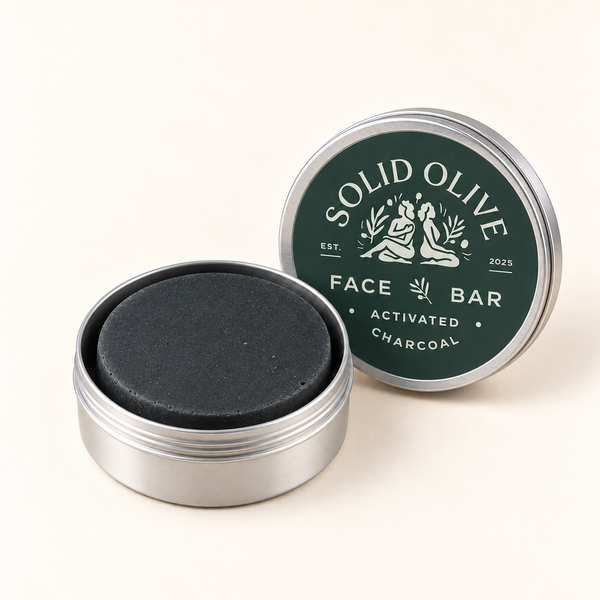 Activated Charcoal Face Bar in an open aluminum tin with its labeled lid