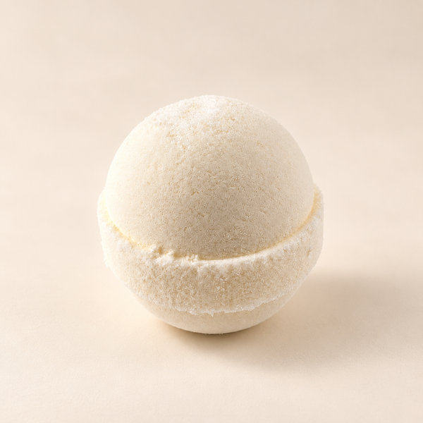 Solid Olive handmade Epsom bath bomb in soft warm lighting