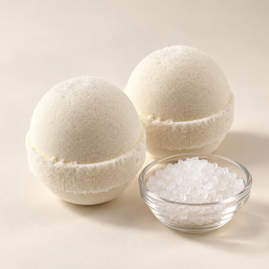 Solid Olive Epsom bath bombs beside a small glass bowl of Epsom salt