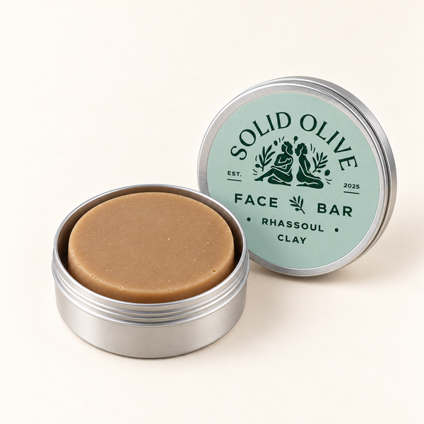 Rhassoul Clay Face Bar in an open aluminum tin with its labeled lid