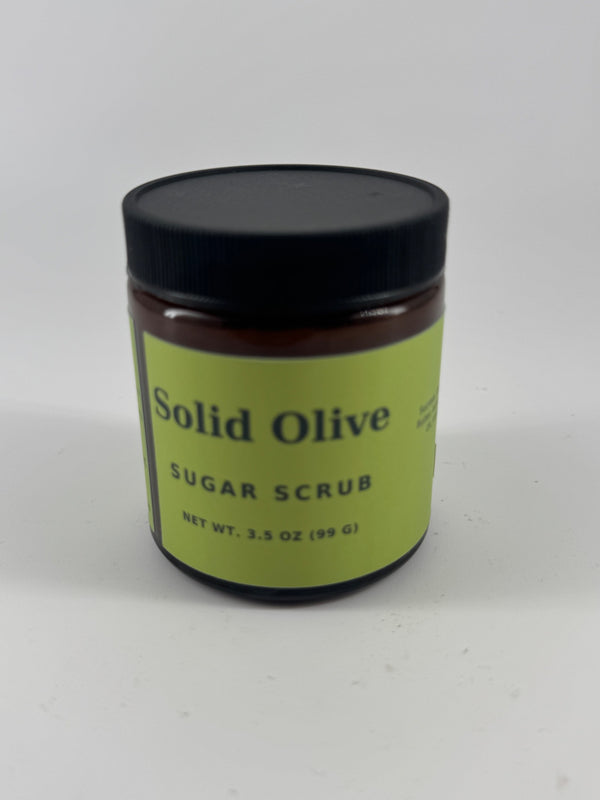 Solid Olive 3.5 oz sugar scrub in an amber glass jar with black lid