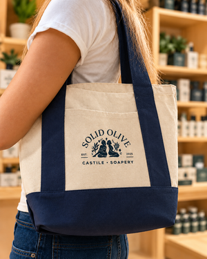 Solid Olive beige and navy tote carried over the shoulder in a soap shop
