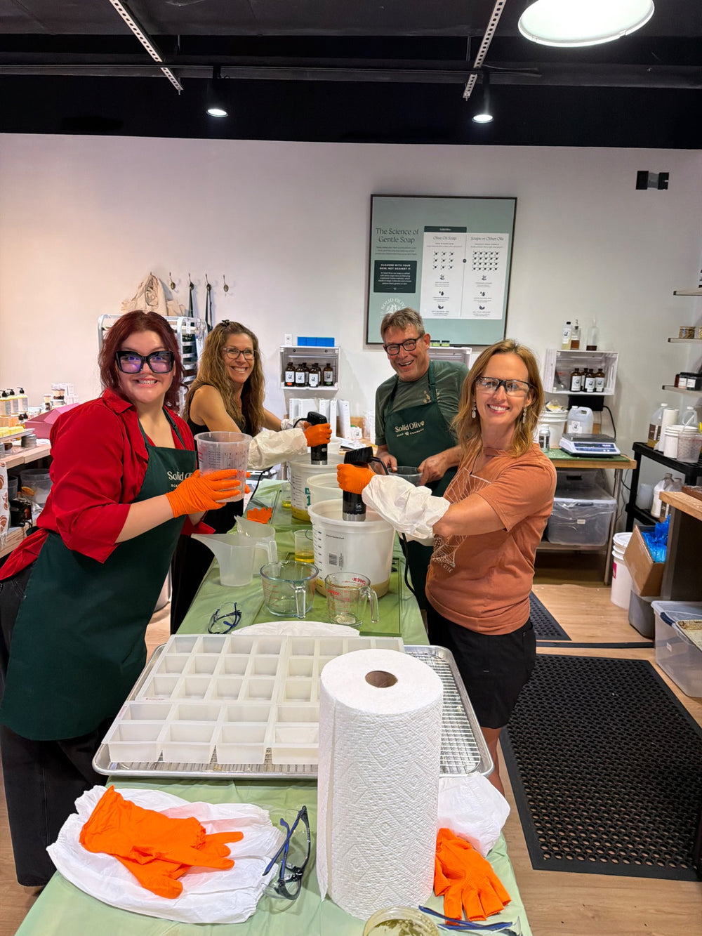 Brad Kellum and workshop attendees mixing soap at Solid Olive